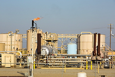 A fracking site being fracked near Wasco in California's Central Valley, USA. Fracking for natural gas and oil, has reduced energy prices in the US, but fracking is a water hungry industry, that competes directly with the agricultural sector for water. After a 4 year long drought water is running out.  Fracking also contaminates ground water supplies from all the chemicals that are pumped underground to frack the fossil fuel bearing rocks.