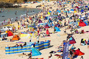 Holiday makers on the beach in St Ives, Cornwall, UK.