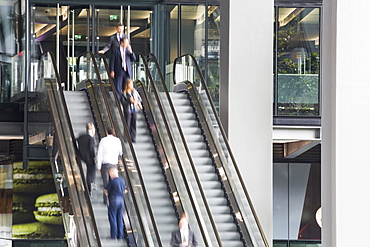 Workers entering and leaving the new Leadenhall building via escalator in the City of London, UK.