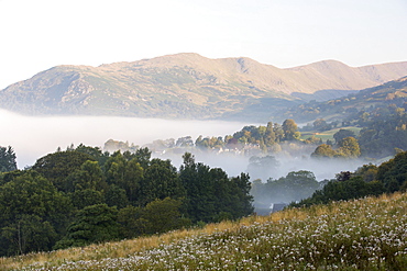 Autumn mists come early to the Lake District, a temperature inversion over Ambleside in the Lake District, taken from the slopes of Wansfell looking towards Fairfield.