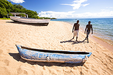 A traditional dug out canoe on a beach at Cape Maclear on the shores of Lake Malawi, Malawi, Africa.