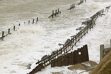 Waves crashing against sea defences at Happisburgh on the fastest eroding section of the UK coast, Norfolk, England, United Kingdom, Europe