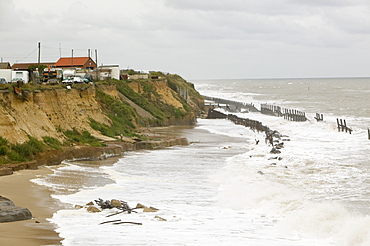 Waves crashing against sea defences at Happisburgh on the fastest eroding section of the UK coast, Norfolk, England, United Kingdom, Europe