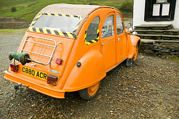 A Citroen 2CV painted bright orange, Lake District, Cumbria, England, United Kingdom, Europe