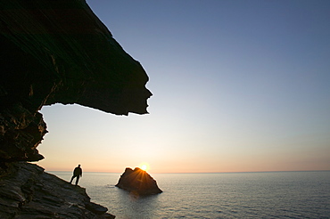 A man on the cliff tops at Boscastle overlooking Meachard Island, Cornwall, England, United Kingdom, Europe