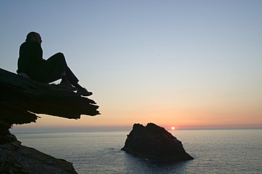 A man on the cliff tops at Boscastle overlooking Meachard Island, Cornwall, England, United Kingdom, Europe