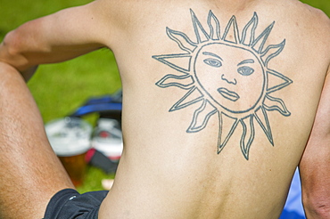 A man with a sun symbol tattoo on his back, Cumbria, England, United Kingdom, Europe