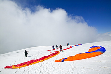 Paraponters preparing to take off from the Grand Montets above Chamonix, Haute Savoie, France, Europe