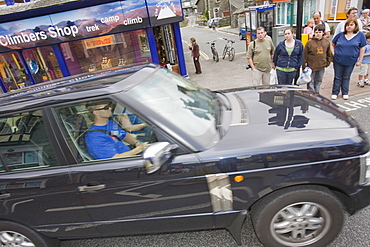 A gas guzzling Chelsea tractor driving through Ambleside, Cumbria, England, United Kingdom, Europe