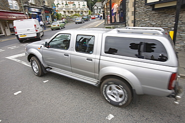 A gas guzzling Chelsea tractor driving through Ambleside, Cumbria, England, United Kingdom, Europe