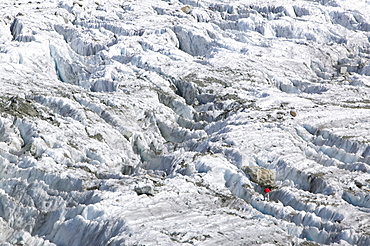 A mountaineer on the Argentiere Glacier, like most Alpine glaciers it is retreating rapidly due to global warming, Chamonix, Haute Savoie, France, Europe