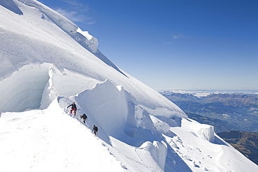 Climbers on the 4000 metre peak of Mont Blanc Du Tacul above Chamonix, Haute Savoie, France, Europe