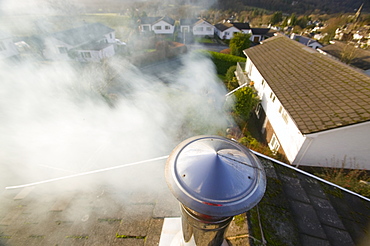 Smoke from a house chimney, Cumbria, England, United Kingdom, Europe