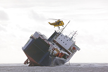 An RAF Sea King Helicopter prepares to drop salvage experts onto the Riverdance washed ashore off Blackpool, Lancashire, England, United Kingdom, Europe