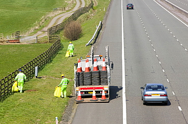 Workers picking litter off the side of the M74 motorway near Lockerbie, Scotland, United Kingdom, Europe