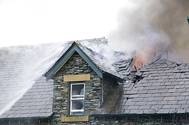 A fire being tackled by firemen in Ambleside, Lake Distruct, Cumbria, England, United Kingdom, Europe