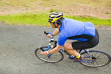 Cyclist descending Wrynose Pass on the Fred Whitton Challenge in the Lake District, Cumbria, England, United Kingdom, Europe