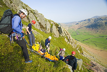 Members of Langdale Ambleside Mountain Rescue Team rescue a fallen climber with a broken leg from Gimmer Crag in Langdale, Lake District National Park, Cumbria, England, United Kingdom, Europe