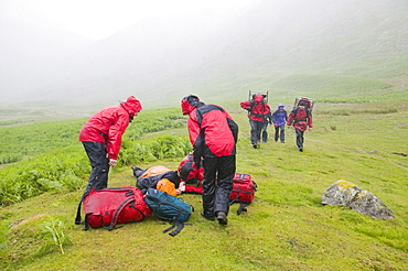 Members of Langdale Ambleside mountain rescue Team treat a collapsed walker suffering from hypothermia in the Lake District, Cumbria, England, United Kingdom, Europe