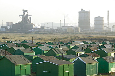 Fishermens huts at South Gare, with the steel plant at Redcar, formerly owned by Corus, now by SSI, Teesside, England, United Kingdom, Europe