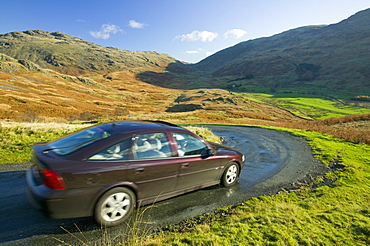 A car descending Hardknott Pass in the Lake District, Cumbria, England, United Kingdom, Europe