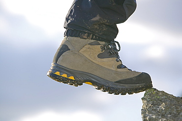 A mountaineer's boot on a rock, Lake District, Cumbria, England, United Kingdom, Europe