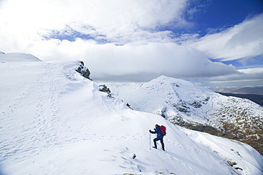 Winter climber ascends An Garbhanach in the Mamore Hills, Scotland, United Kingdom, Europe