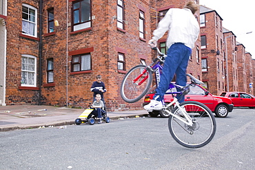 Kids playing around tenement blocks on Barrow Island, Barrow in Furness, Cumbria, England, United Kingdom, Europe