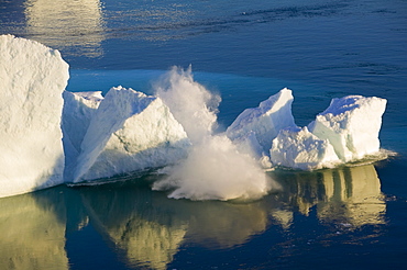 An arched iceberg collapsing into the sea from the Jacobshavn Glacier (Sermeq Kujalleq), Greenland, Polar Regions