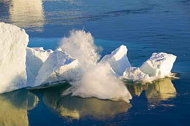 An arched iceberg collapsing into the sea from the Jacobshavn Glacier (Sermeq Kujalleq), Greenland, Polar Regions