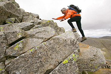 A climber scrambling in Eskdale in the Lake District, Cumbria, England, United Kingdom, Europe