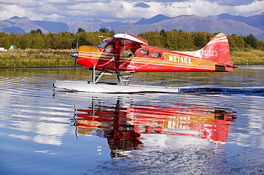 A float plane flying into Anchorage, Alaska, United States of America, North America