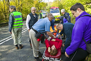 The Langdale Ambleside Mountain Rescue Team stretcher a casualty to the roadside, Cumbria, England, United Kingdom, Europe