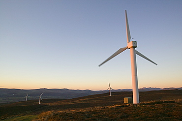 A wind farm looking towards the Coniston Fells in the Lake District, Cumbria, England, United Kingdom, Europe