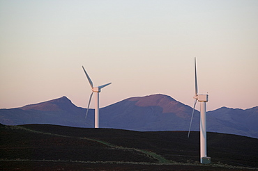 A wind farm looking towards the Coniston Fells in the Lake District, Cumbria, England, United Kingdom, Europe