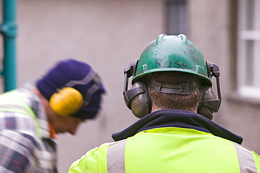 Workmen using ear protectors