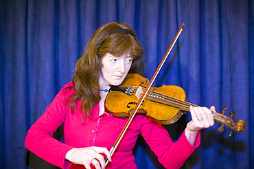 A woman playing the violin