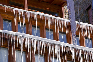 Icicles hanging from a chalet roof in the Andorran ski resort of Soldeu el Tarter, Andorra, Europe