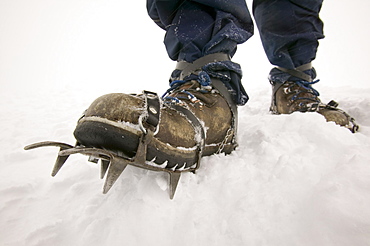 A climber wearing crampons