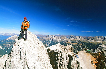 A mountaineer on a summit in the Italian Dolomites, Italy, Europe