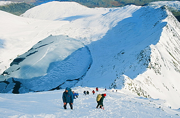 Climbers ascend Helvellyn from Striding Edge in the Lake District National Park, Cumbria, England, United Kingdom, Europe