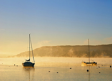 Morning mist over Lake Windermere in the Lake District National Park, Cumbria, England, United Kingdom, Europe