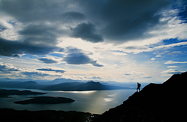 A walker on Ben Mhor Coigach in the north West Highlands of Scotland, United Kingdom, Europe