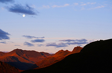 The moon over Bowfell and the Langdale Pikes in the Lake District National Park, Cumbria, England, United Kingdom, Europe