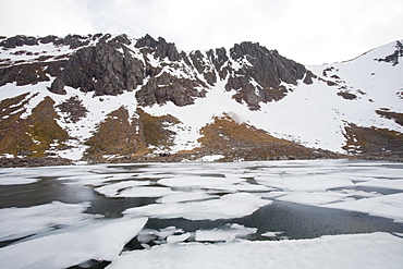 A frozen lochan in Corrie an Lochain in the Cairngorm mountains, Scotland, United Kingdom, Europe