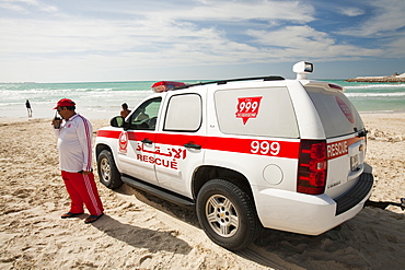 A police emergency vehicle on a public beach in Dubai, United Arab Emirates, Middle East