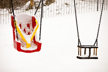 Playground swings in the snow in Ambleside, Cumbria, England, United Kingdom, Europe