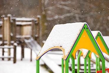 Playground swings in the snow in Ambleside, Cumbria, England, United Kingdom, Europe