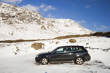 A car abandoned in the snw on Kirkstone Pass in the Lake District, Cumbria, England, United Kingdom, Europe