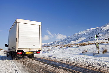 A vehicle on Kirkstone Pass in winter, Lake District, Cumbria, England, United Kingdom, Europe